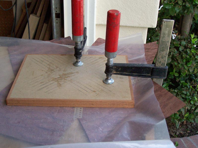 Press the veneer to keep it flat as it dries